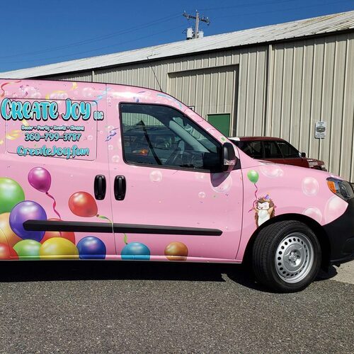 pink van with a vinyl wrap
